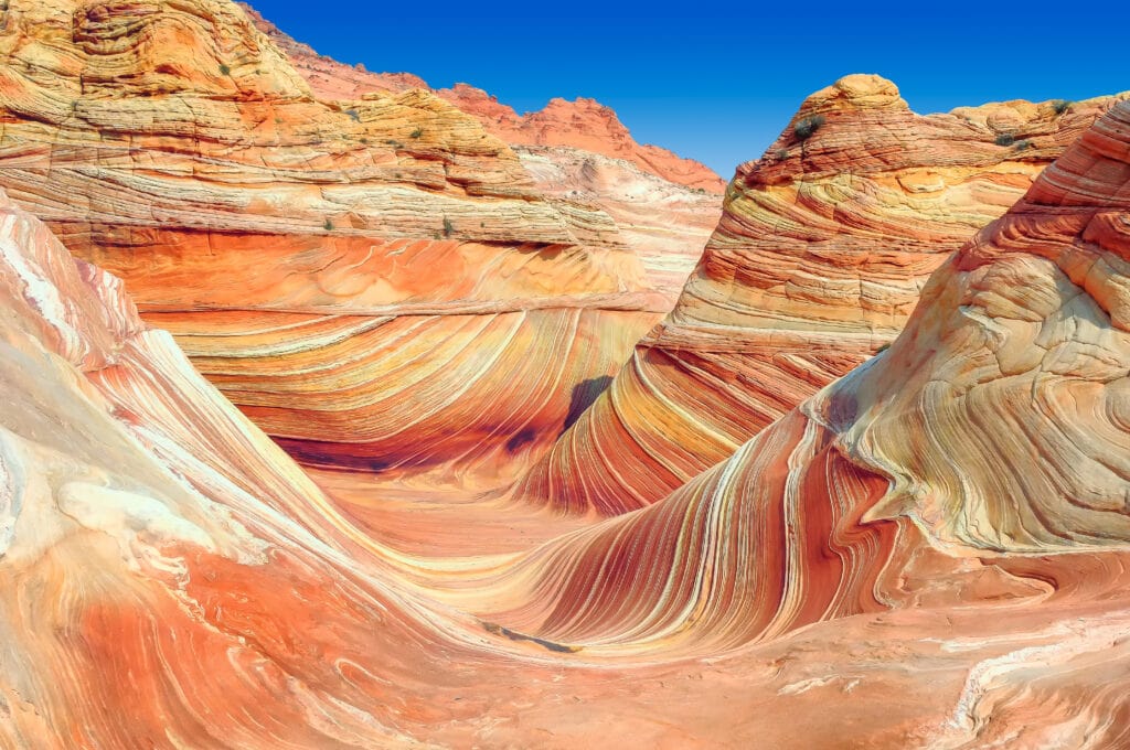swirly, orange and cream layered sandstone landform